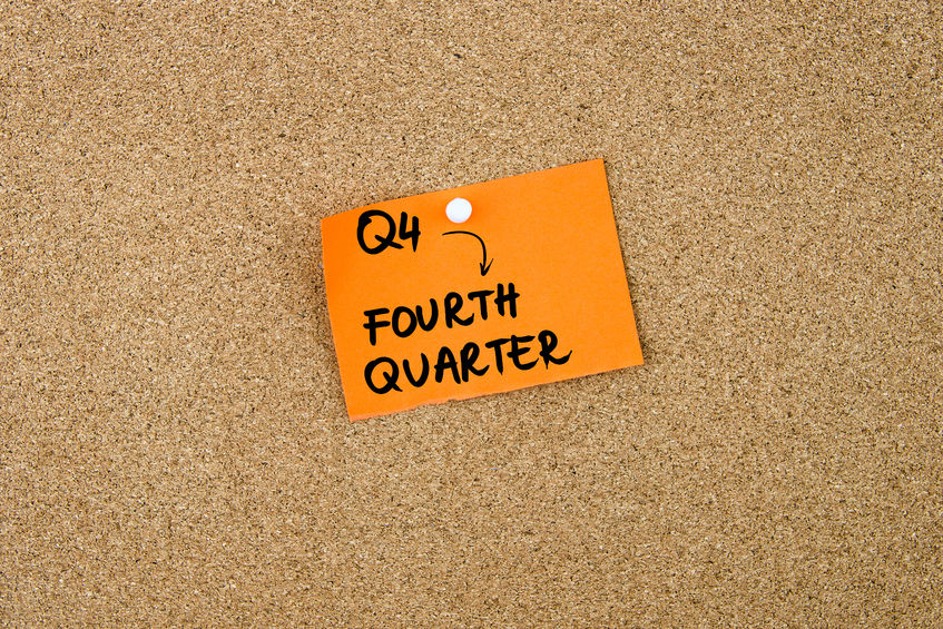 Orange sticky note on corkboard that reads "Fourth Quarter"