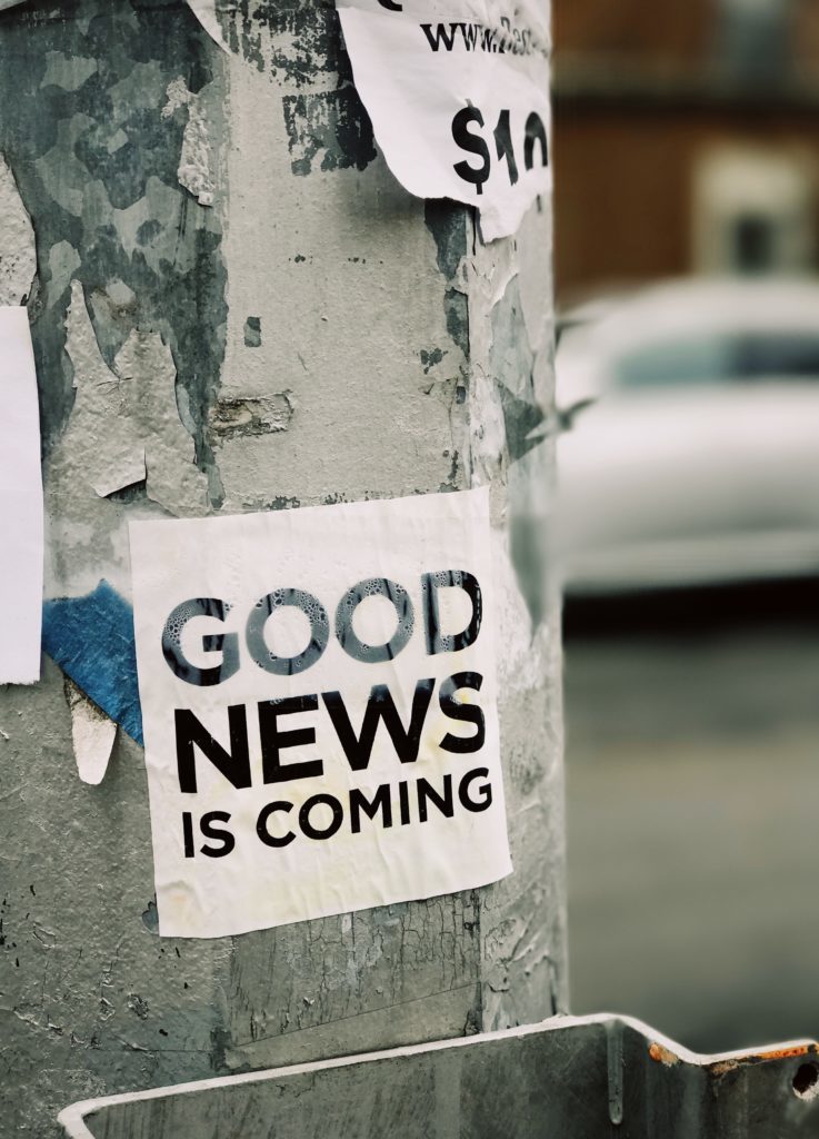 Scruffy Sign on an electric pole that reads "good news is coming"