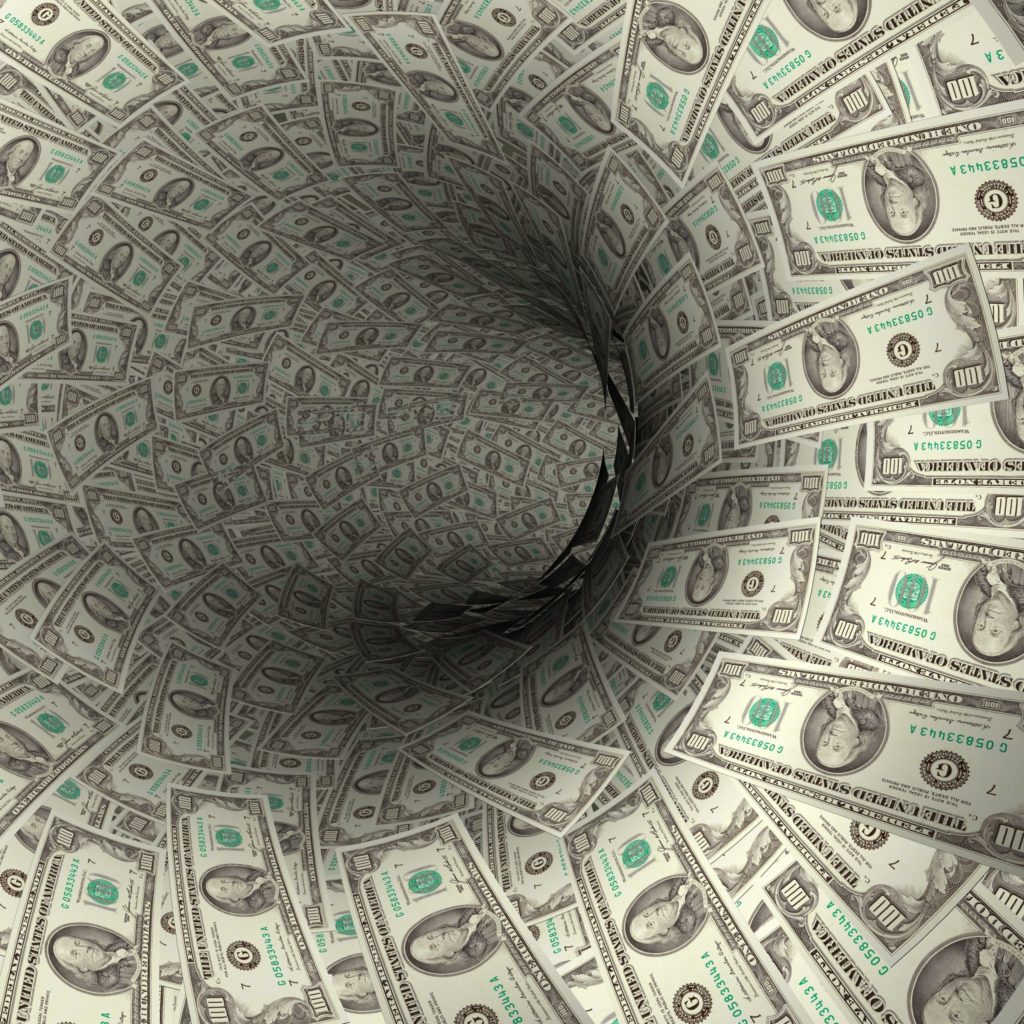 Money falling down a hole, concept for sunk cost fallacy