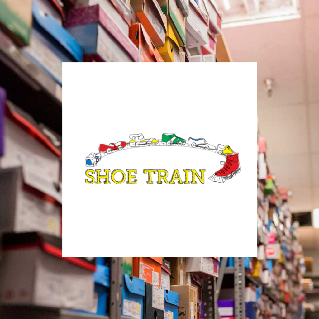 Shoe Train Logo with shoe boxes behind it
