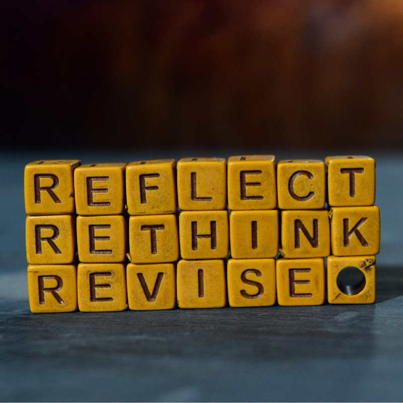 Orange Blocks with words "reflect rethink revise" on them