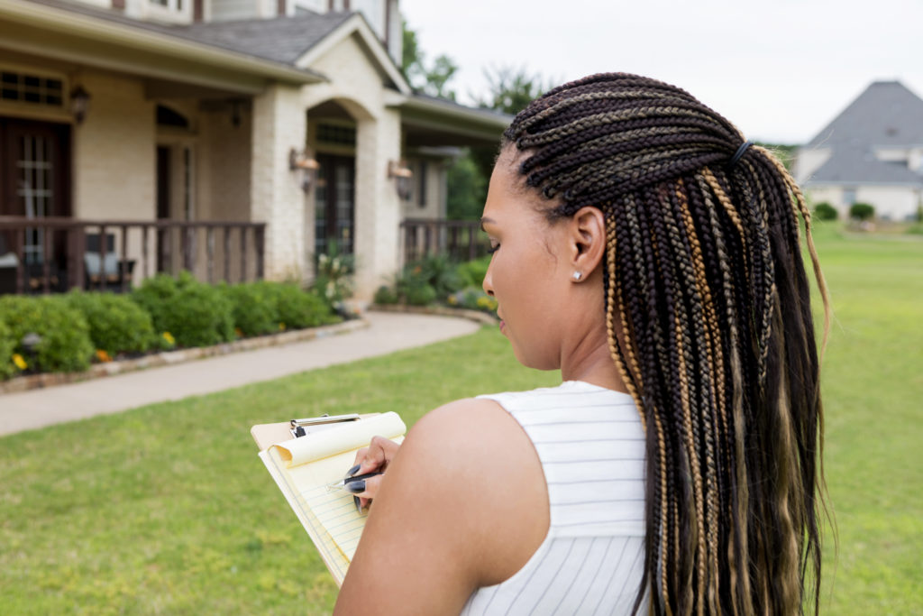 Woman evaluating a property